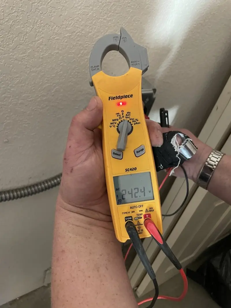 Voltage testing with clamp meter during Recessed Lighting Installation in Lakewood